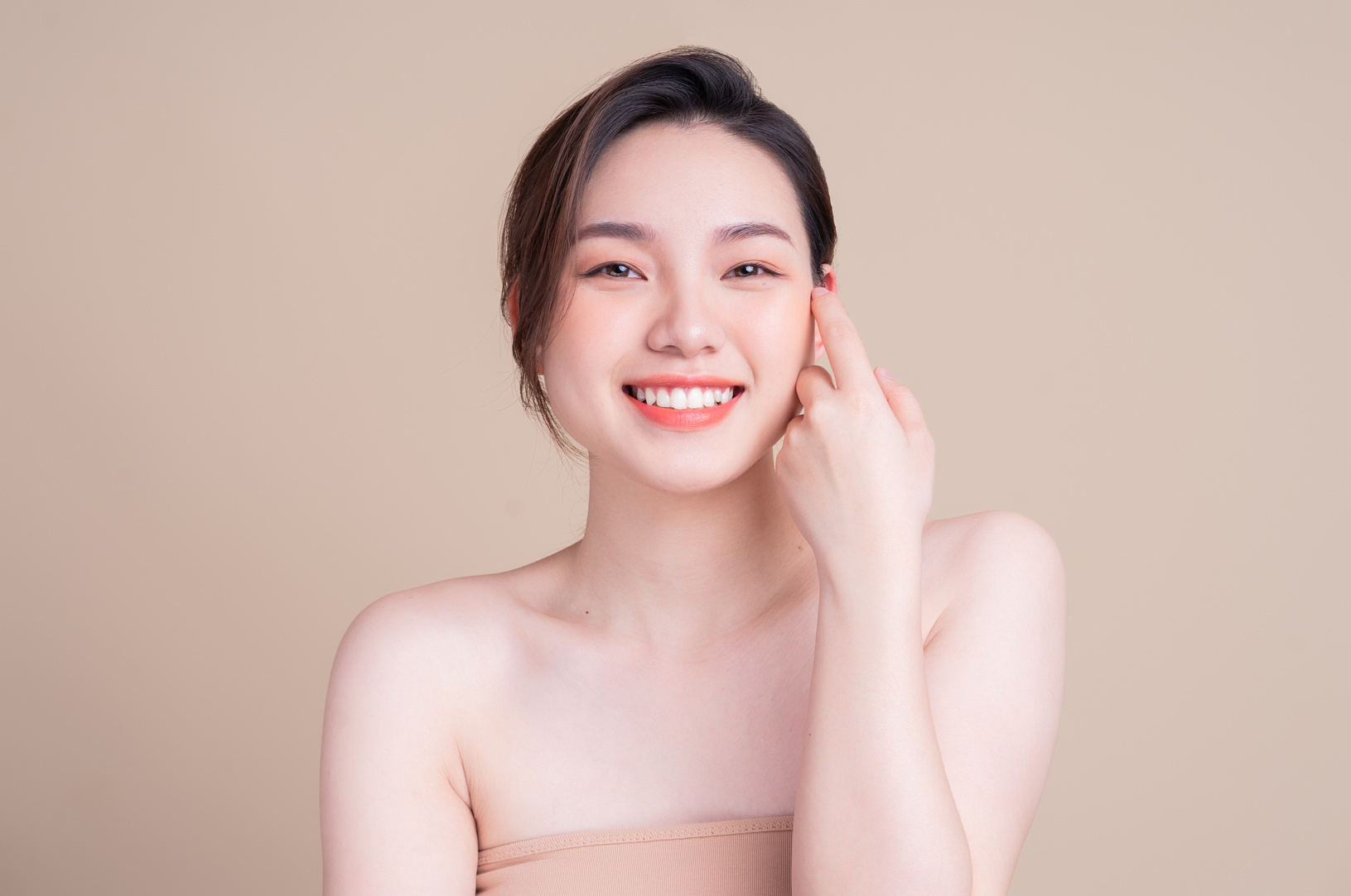 Attractive Young Asian Woman with Fresh Skin. Face Care, Facial Treatment, , Woman Beauty Skin Isolated on White Background. Cosmetology, Beauty Skin and Cosmetic Concept